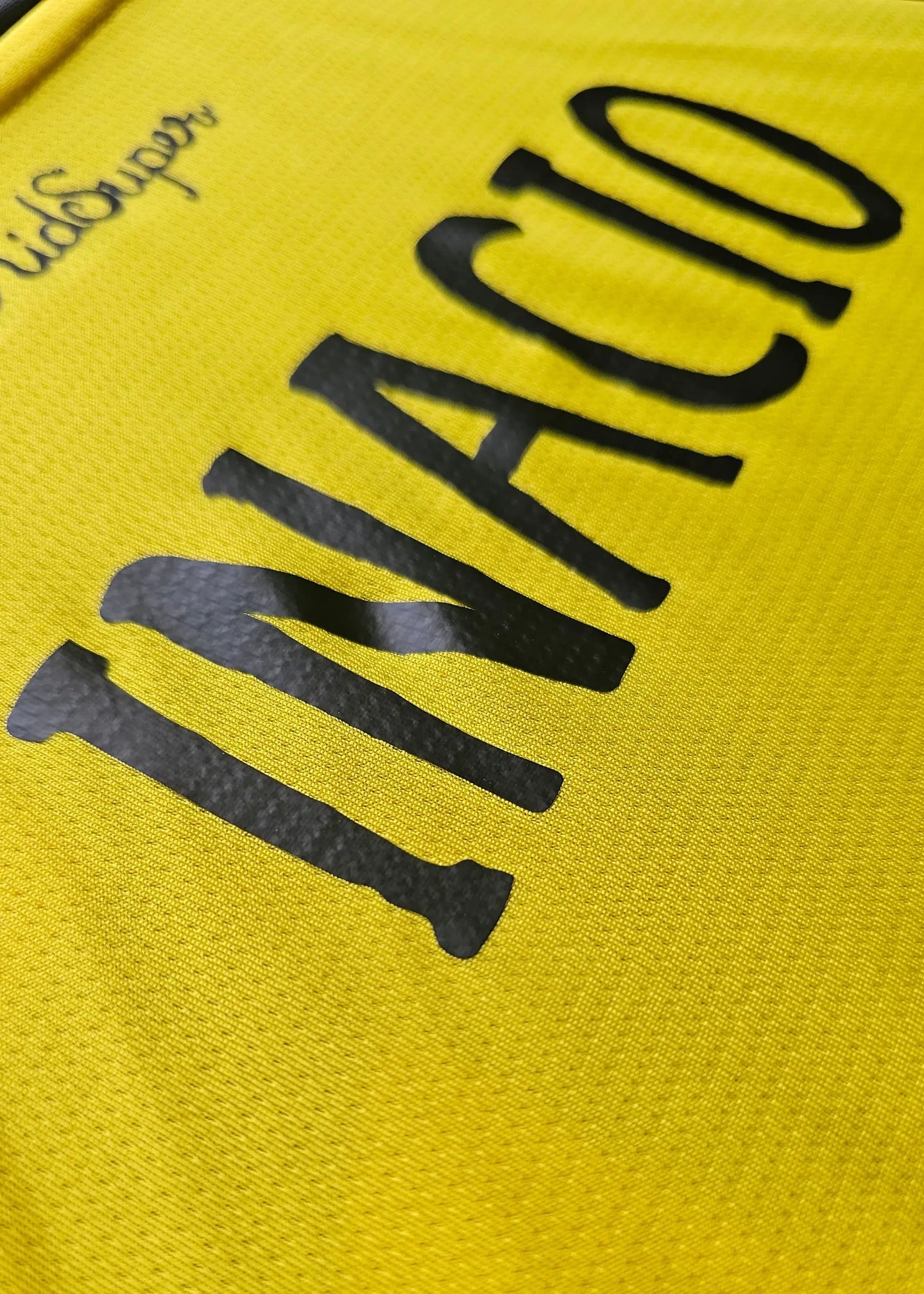 Close-up view of the signature and name 'INACIO' in bold black on a yellow background.