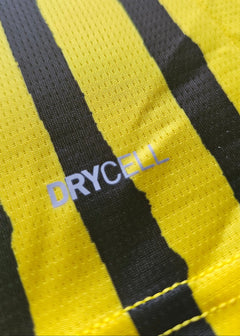 Close-up of yellow and black stripes with visible 'DRYCELL' text on fabric.