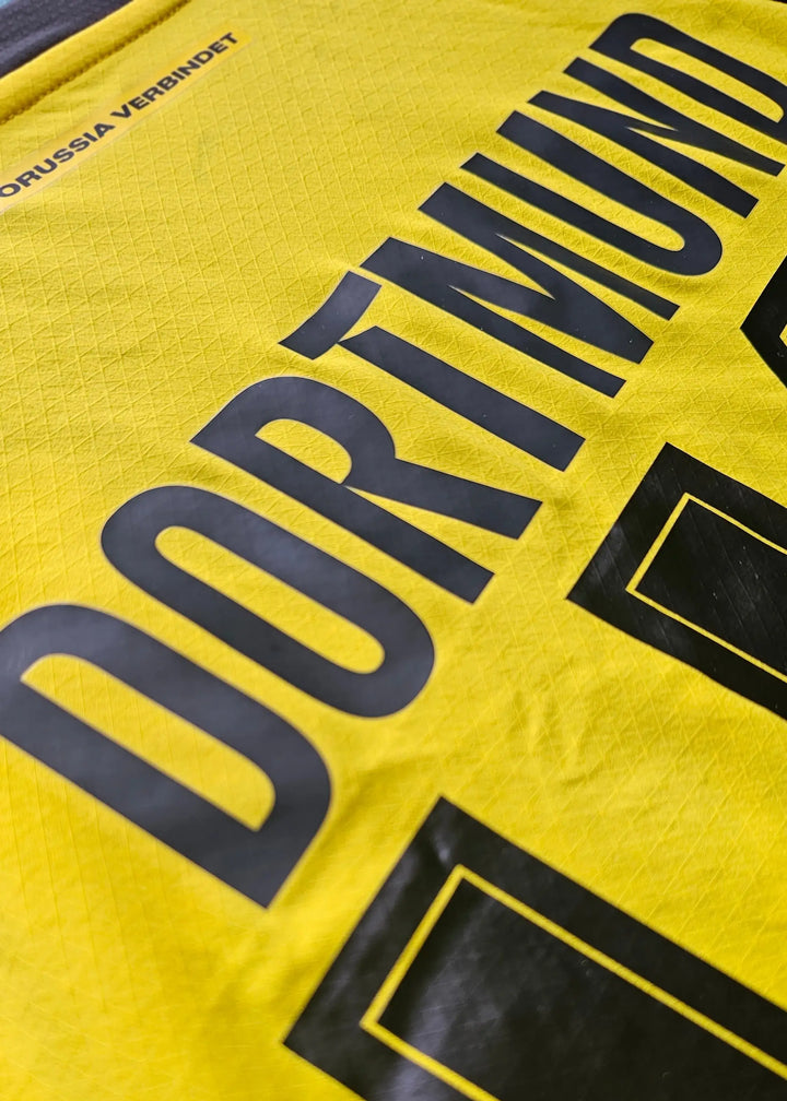 Detail showing Borussia Dortmund in bold black letters on a yellow background.