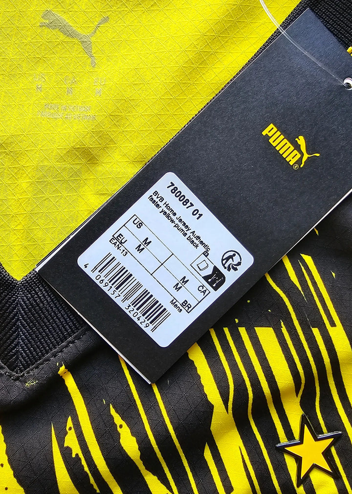 Detail of Borussia Dortmund shirt tag showing Puma branding and size information.