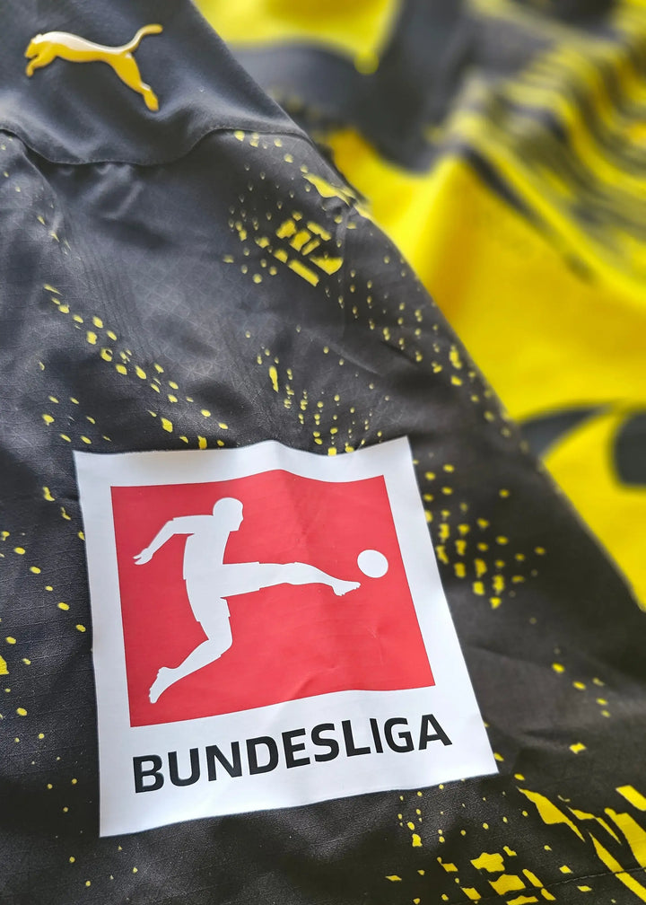 Detail view of the Borussia Dortmund crest with Bundesliga logo and Puma branding.