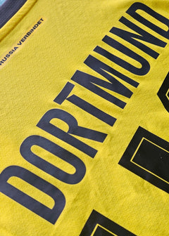 Back view featuring Dortmund text and squad number 30 in black on a yellow football shirt.