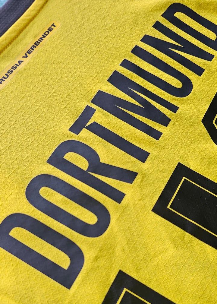 Back view featuring Dortmund text and squad number 30 in black on a yellow football shirt.