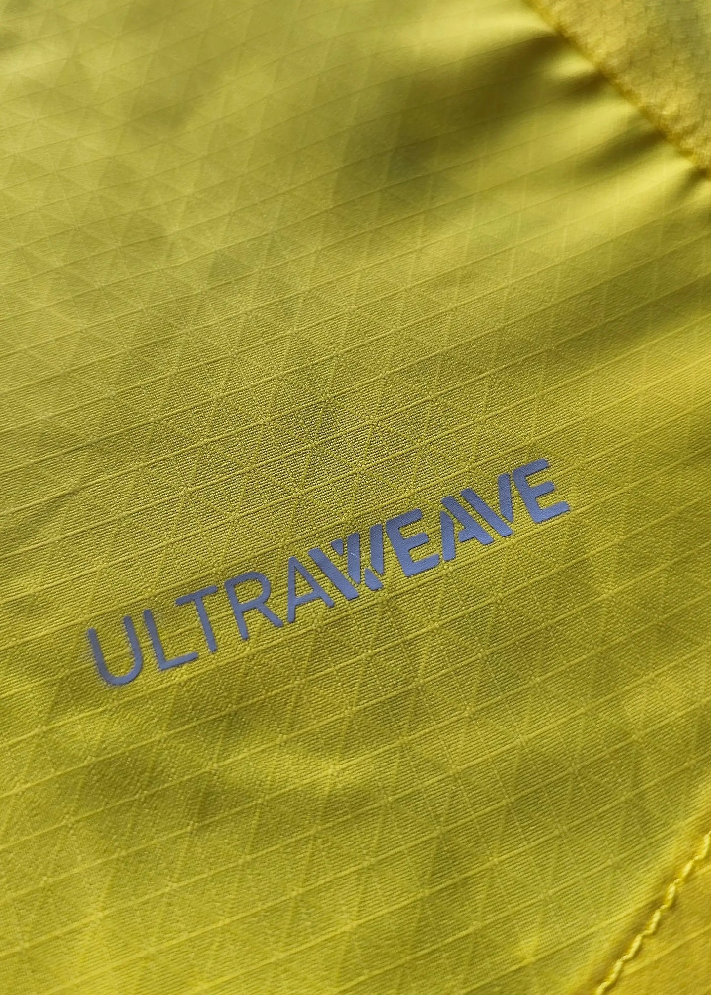 Close-up showing the textured yellow fabric with 'ULTRAWEAVE' branding in blue.