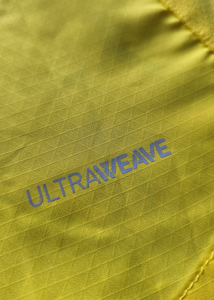 Close-up showing the textured yellow fabric with &