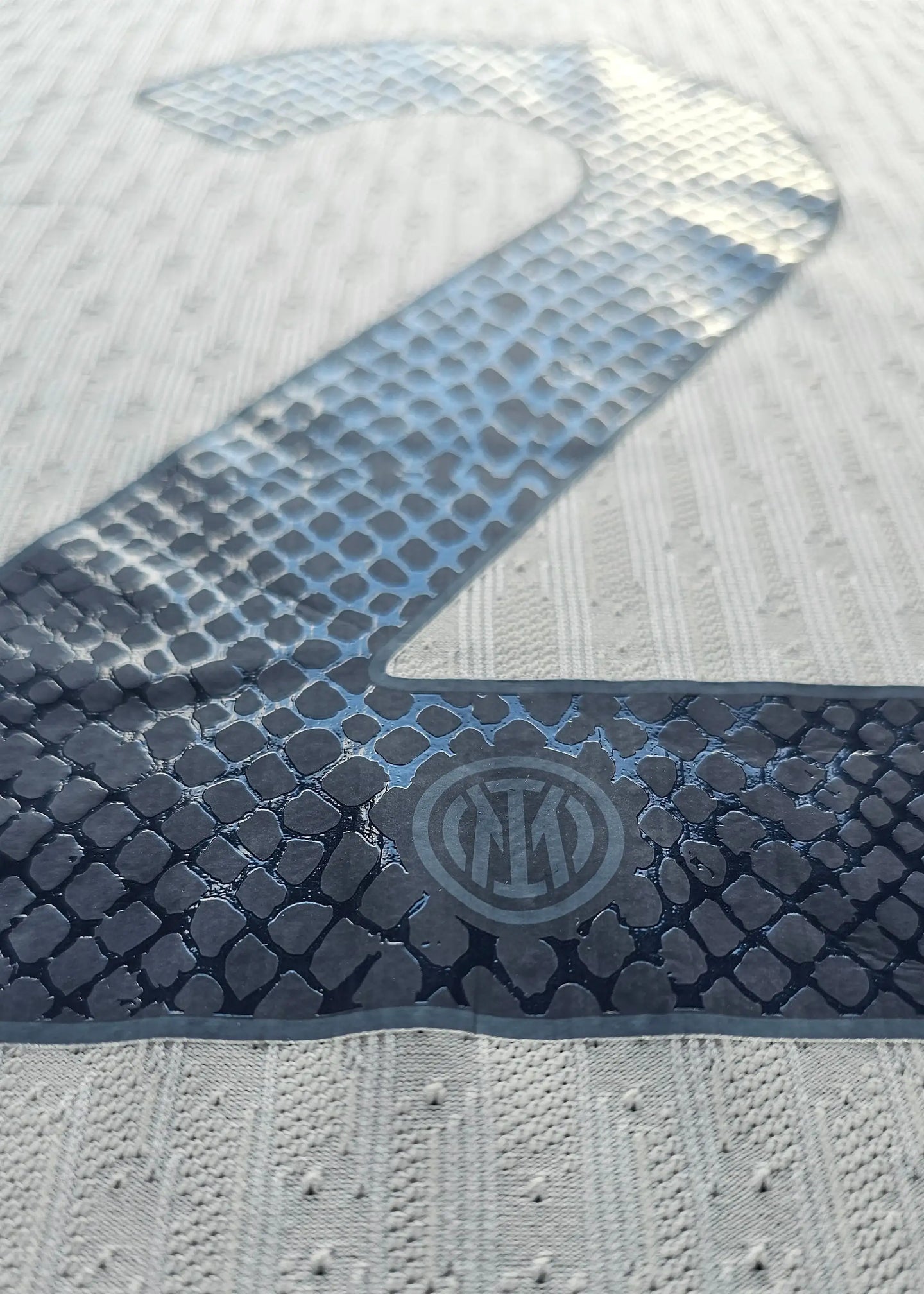 Close-up of the No. 2 with Inter Milan crest visible underneath.