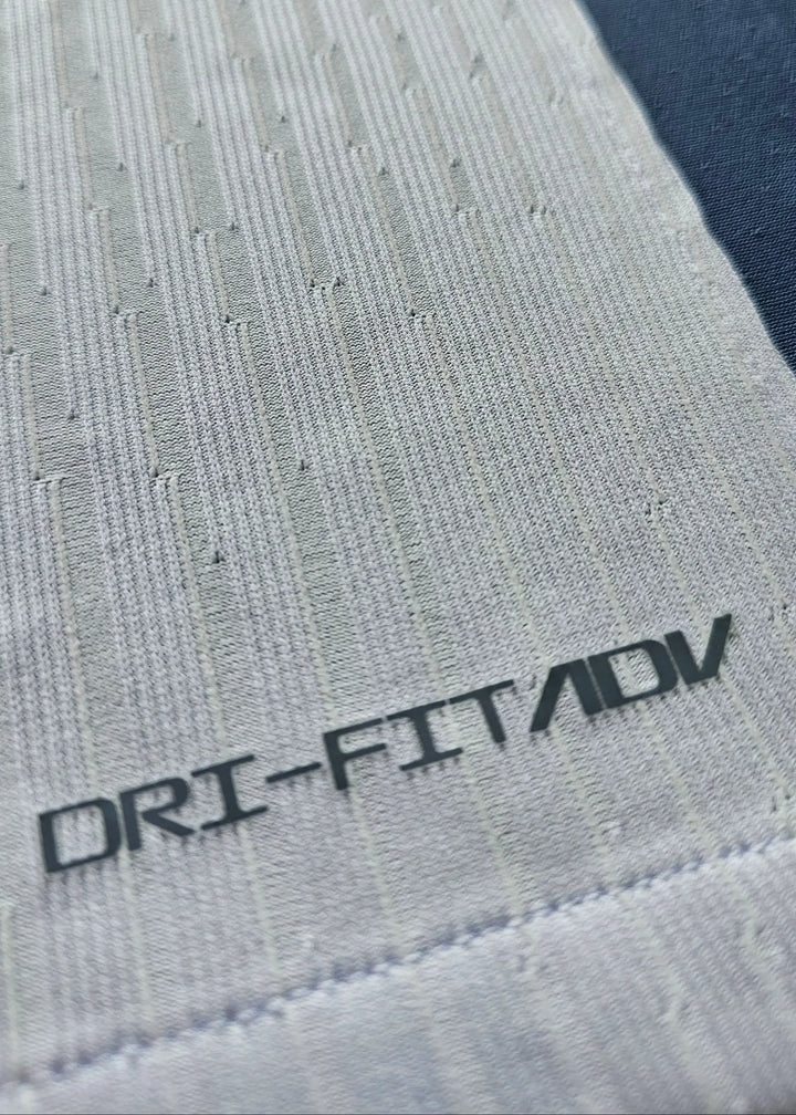 Close-up of fabric detail showing DRI-FIT/ADV technology on the signed Internazionale football shirt.