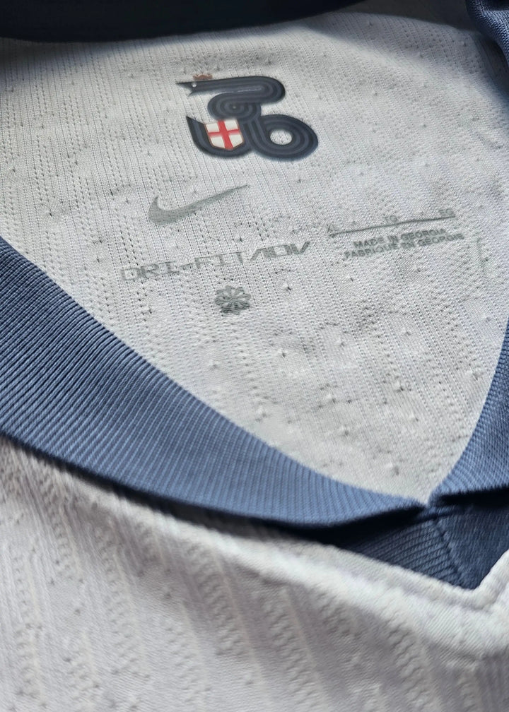 Close-up of collar detail featuring Nike logo and care label text.