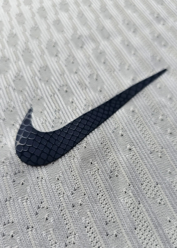 Close-up detail showing the textured Nike logo on the signed Denzel Dumfries Inter Milan shirt.