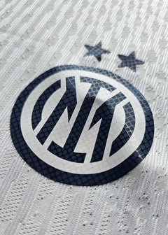 Crest detail featuring Inter Milan logo and two stars above on a white background.