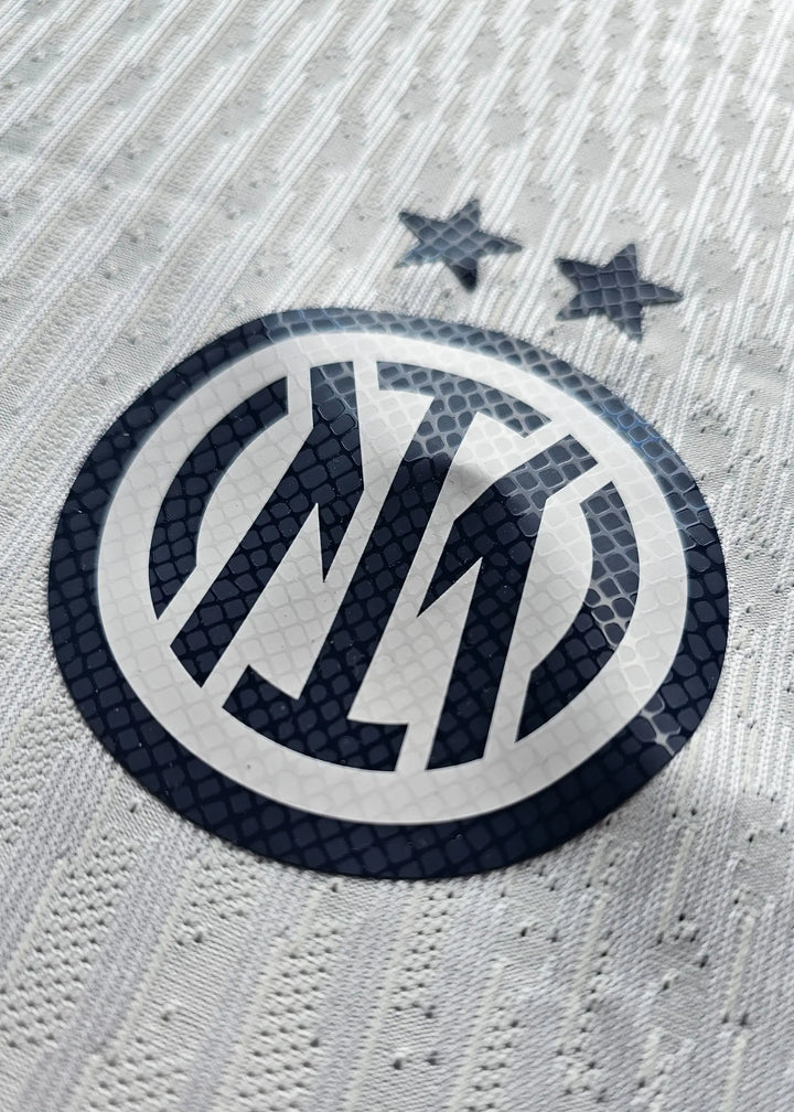 Crest detail featuring Inter Milan logo and two stars above on a white background.