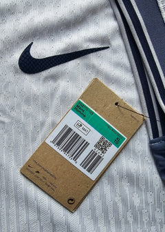 Close-up of the Nike logo and care tag detail on a signed Denzel Dumfries Inter Milan away shirt.