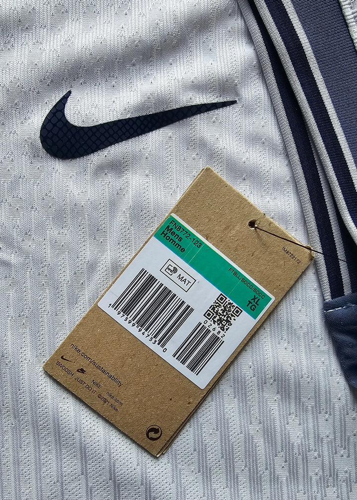 Close-up of the Nike logo and care tag detail on a signed Denzel Dumfries Inter Milan away shirt.
