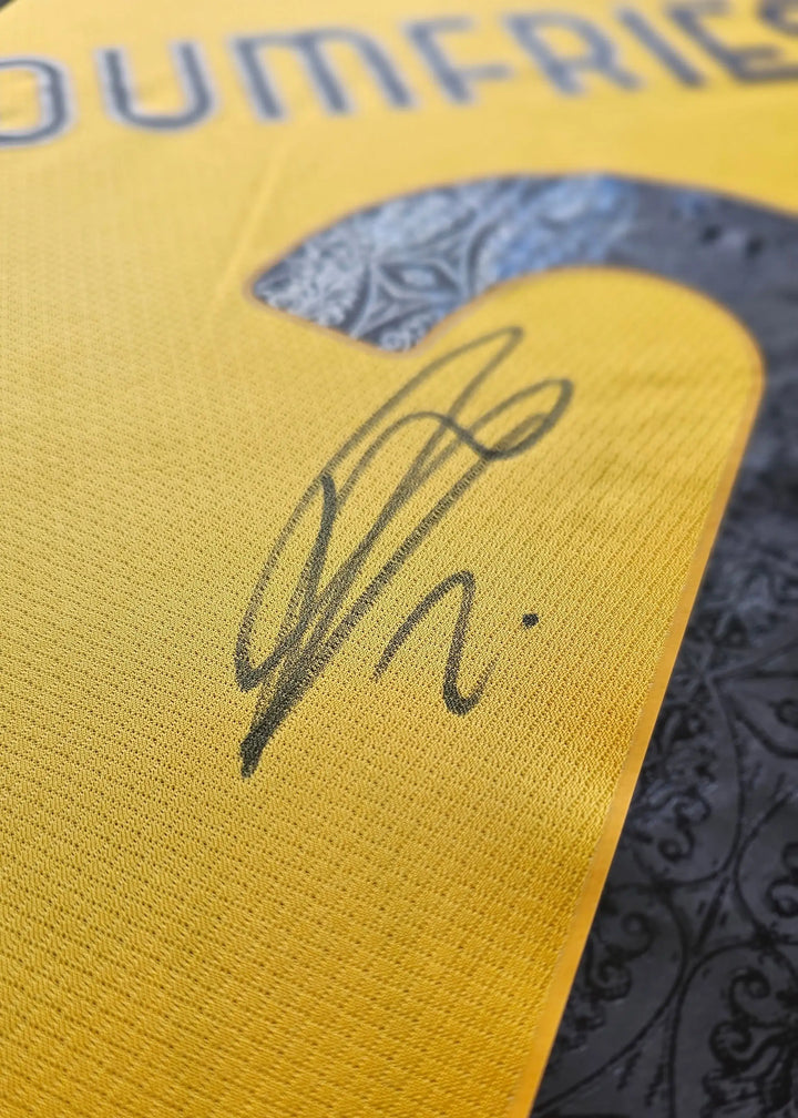Detail view showcasing the signature of Dumfries on a yellow soccer jersey with the number 2.