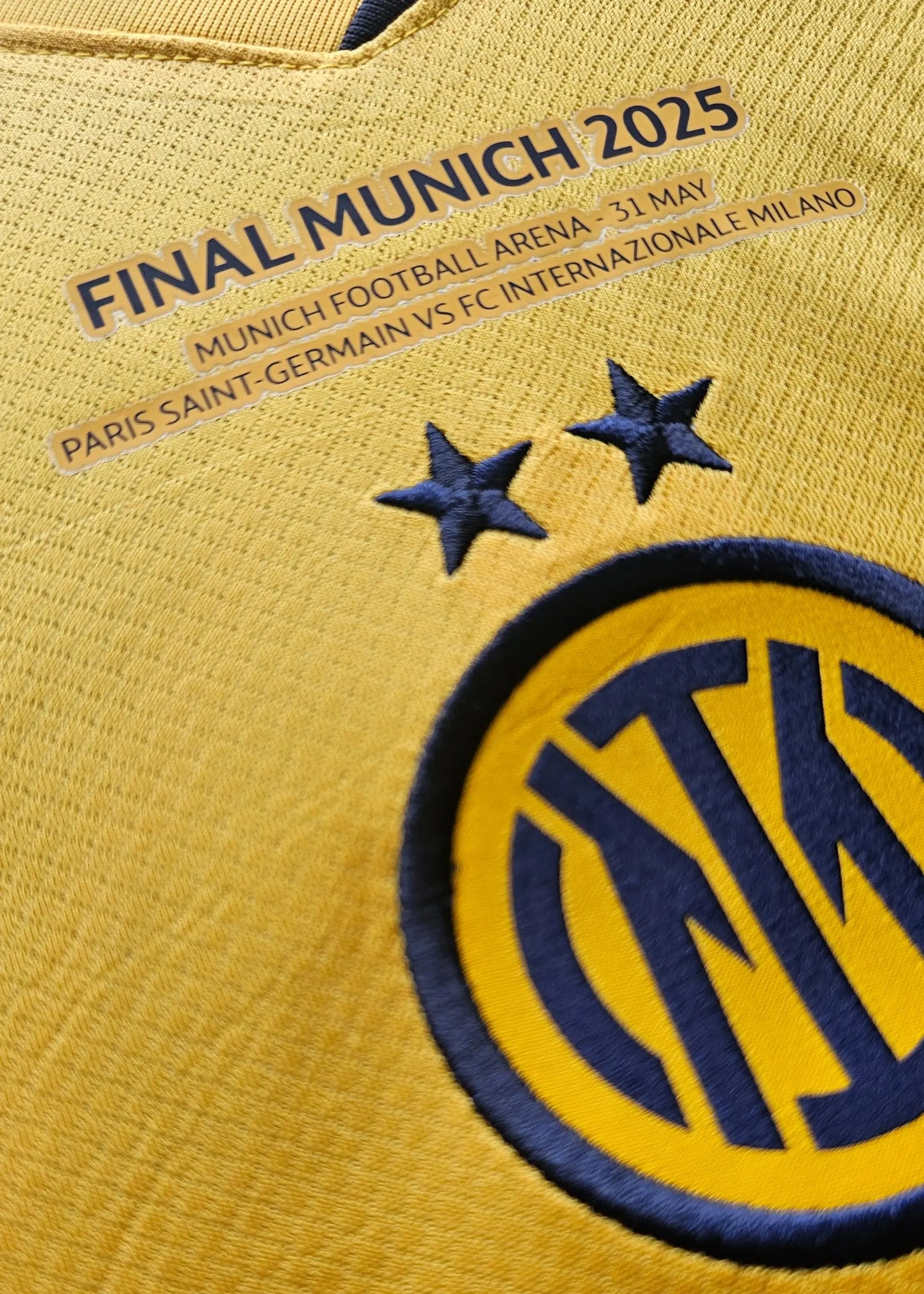 Close-up showing the Inter Milan crest, two stars, and text: FINAL MUNICH 2025, PARIS SAINT-GERMAIN VS FC INTERNAZIONALE MILANO.