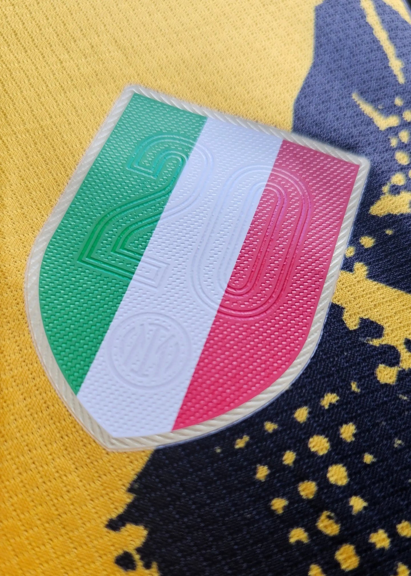 Crest detail featuring the number 20 and Italian flag colors on a yellow background.