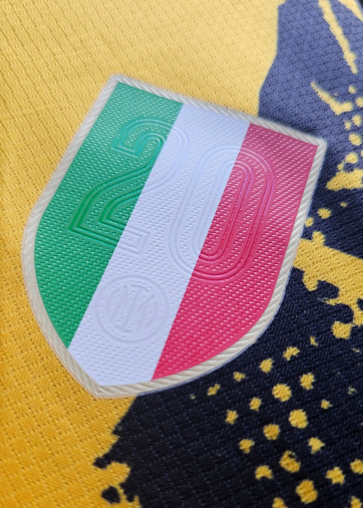 Crest detail featuring the number 20 and Italian flag colors on a yellow background.