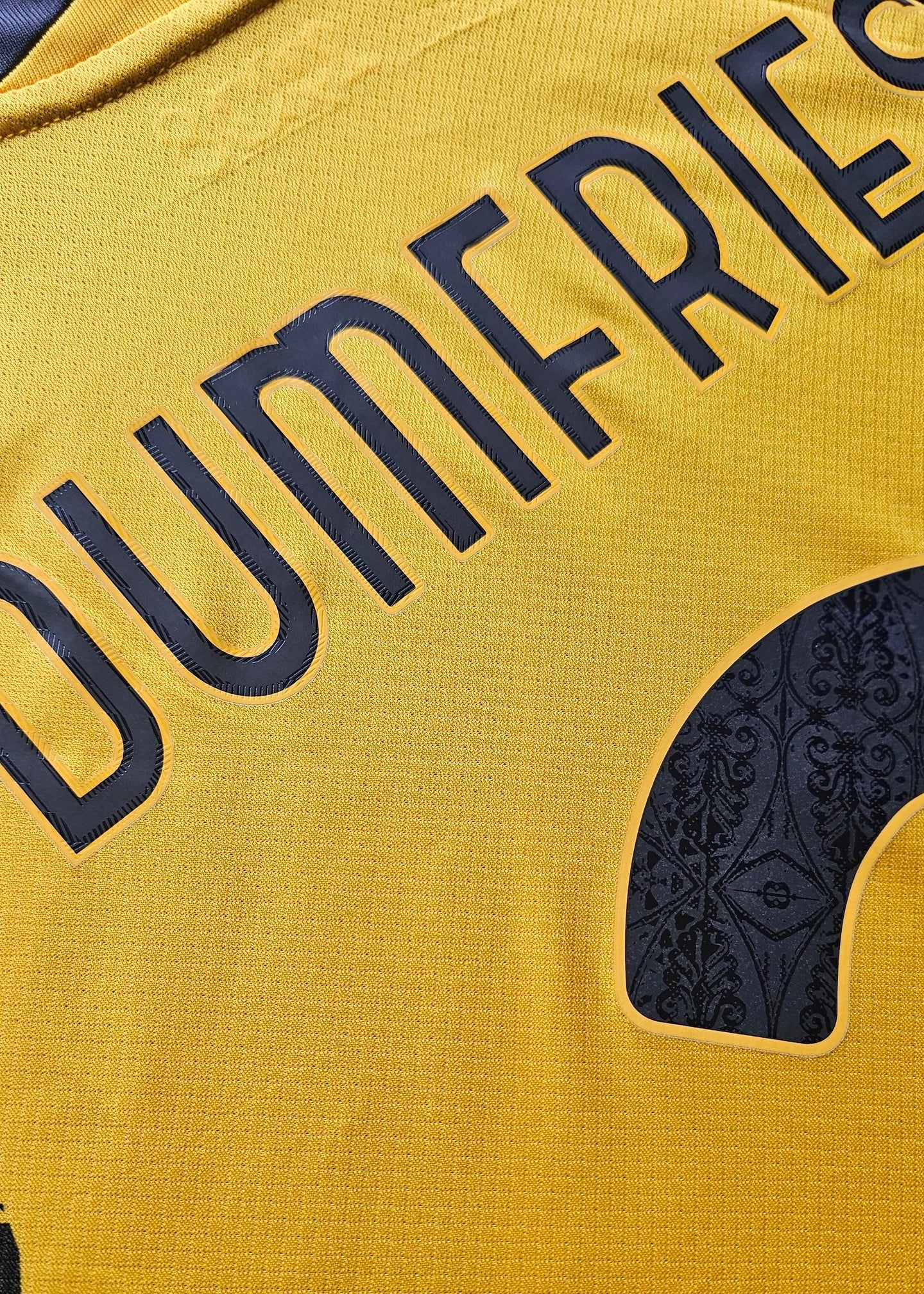 Back view showing No. 2 and Dumfries in bold black lettering on a yellow football shirt.
