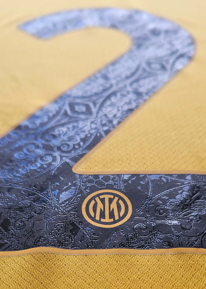 Close-up of the No. 2 detail with Inter Milan crest on a yellow background.