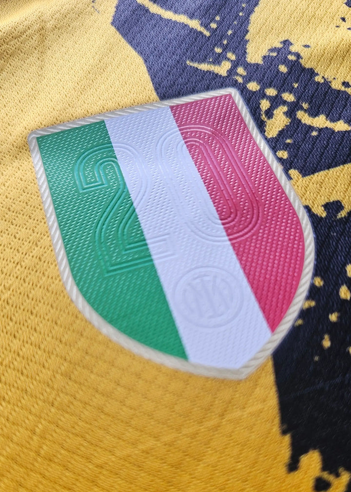 Close-up of Inter Milan crest detail featuring green, white, and red with the number 2.