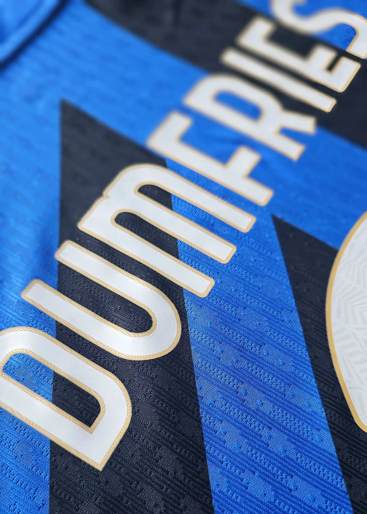 Close-up detail showing the name Dumfries on the signed football shirt in black and blue.