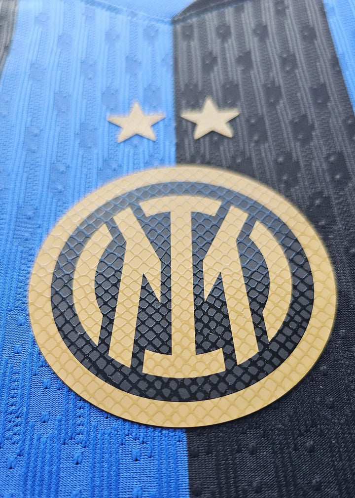 Crest detail featuring Inter Milan logo with two stars above in blue and black colors.