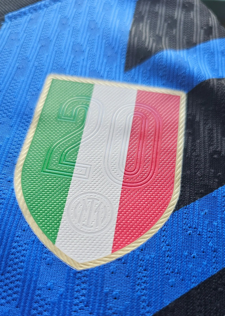 Close-up of the Inter Milan crest featuring an embossed design with the number 2 and Italian flag colors.
