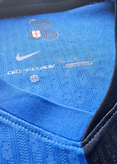 Neck area showing Nike logo, Dri-FIT tag, and size label (XL) on blue fabric.