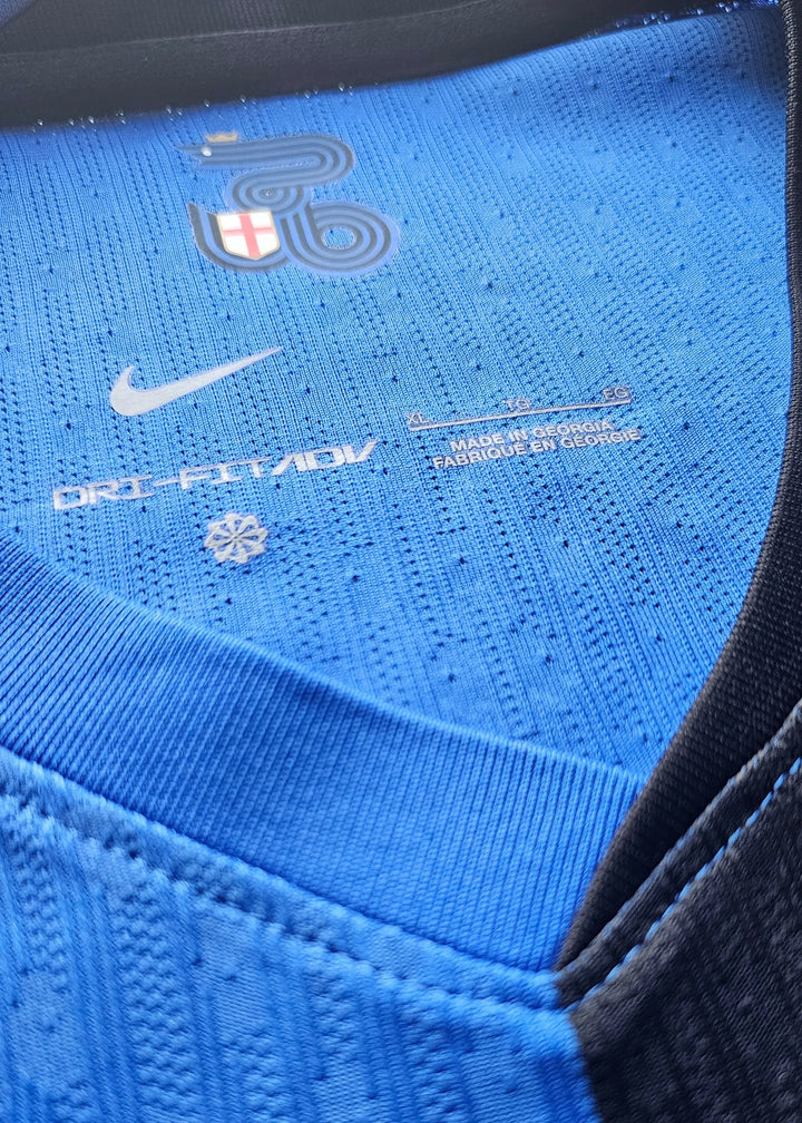 Neck area showing Nike logo, Dri-FIT tag, and size label (XL) on blue fabric.