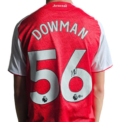 Back view featuring Dowman, No. 56, and a visible signature on a red Arsenal football shirt.