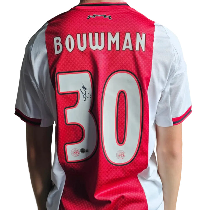 Back view showing No. 30, name 'Bouwman', and signature detail on red and white shirt.