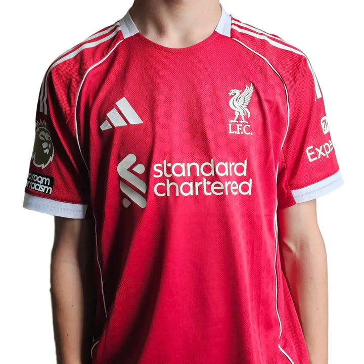 Back view showing Liverpool crest, standard chartered sponsor, and adidas logo in red.