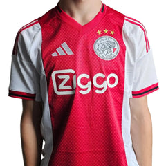 Front view of signed Ajax football shirt featuring Ziggo sponsorship and three stars above the crest.