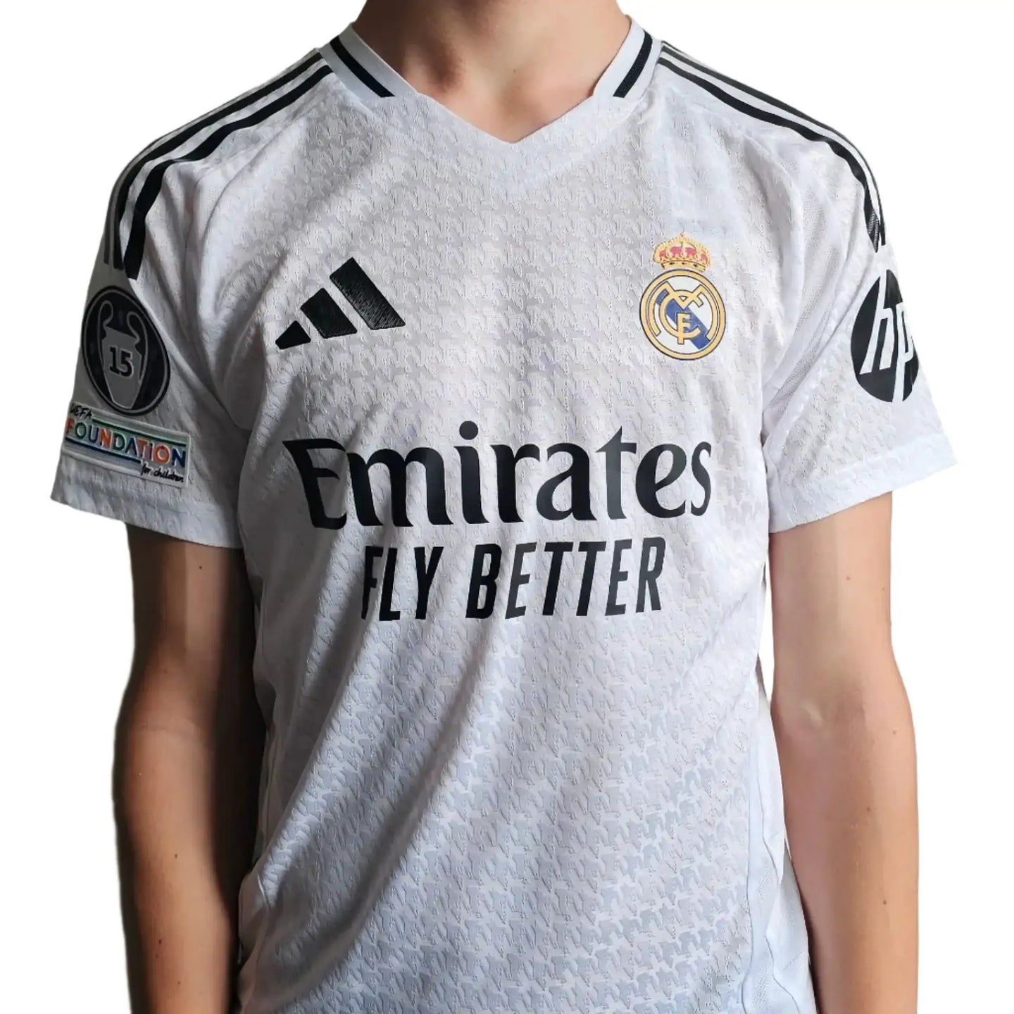 Front view showing 'Emirates', 'FLY BETTER', and Real Madrid crest on a white football shirt.