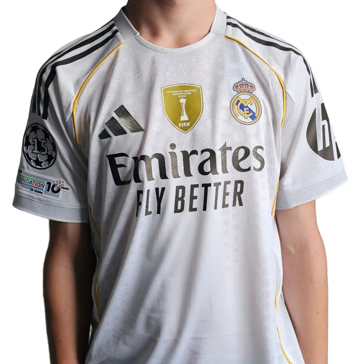Front view displaying the Real Madrid crest, adidas logo, and Emirates sponsor on a white football shirt.