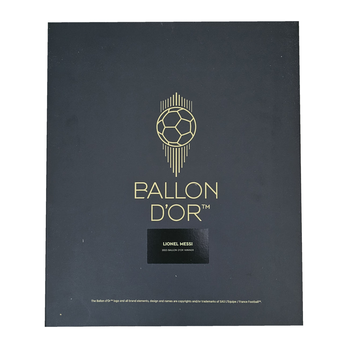 Ballon d'Or presentation box lid, gold ball logo above a Lionel Messi plaque, from his signed Barcelona 2020-21 shirt.