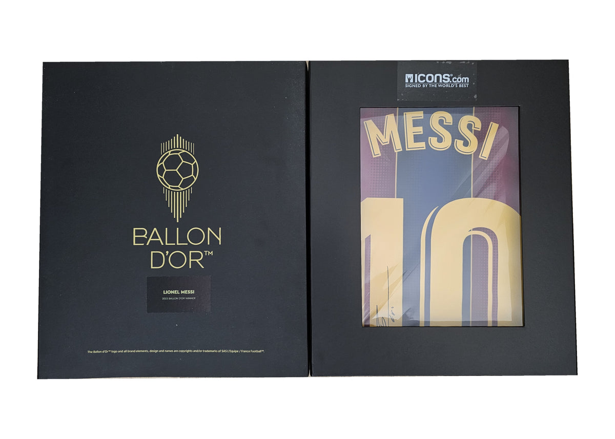Ballon d'Or presentation box open across both panels, Messi's signed Barcelona 2020-21 shirt framed in the right window.