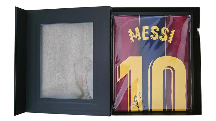 A boxed Lionel Messi autographed FC Barcelona jersey displayed inside a black presentation box with a glass window showing an autograph.