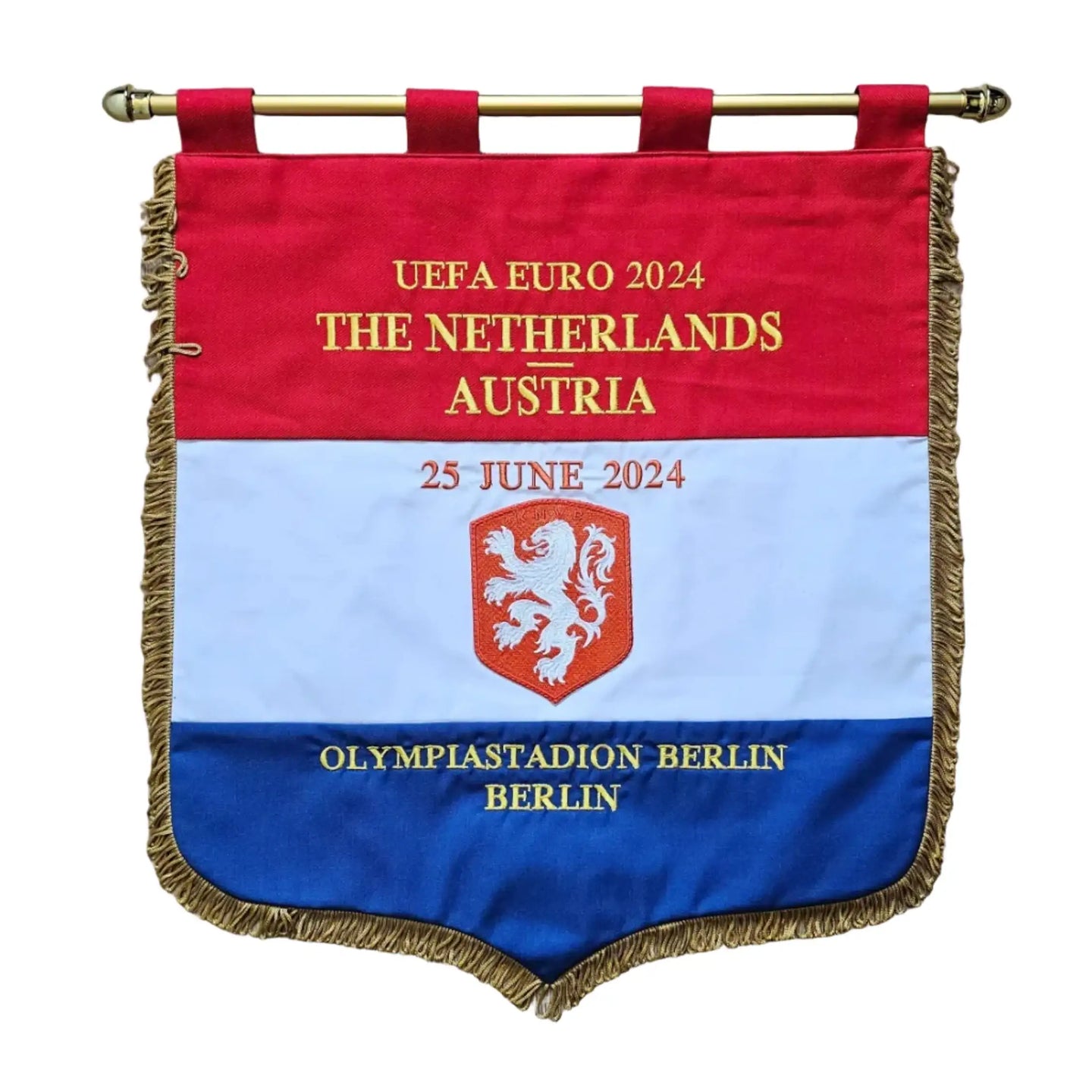 A custom UEFA Euro 2024 Austria flag hanging on a wooden wall. The flag features the red, white, and blue horizontal stripes of the Netherlands flag with gold fringe.
