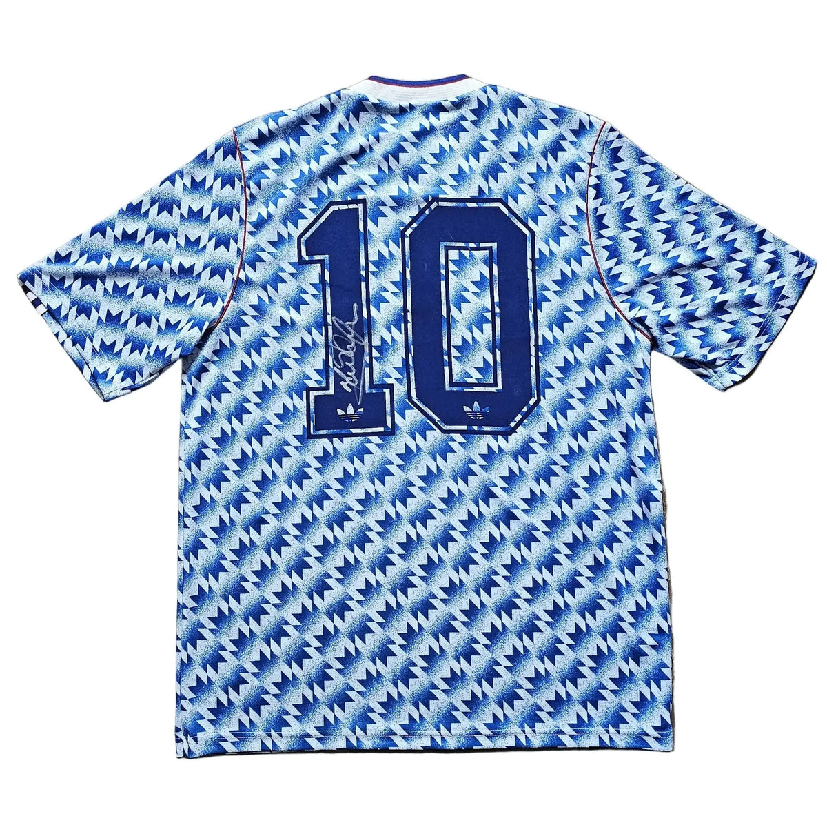Back of a blue-and-white zigzag Manchester United away shirt, number 10 in navy with a signature across it, from Mark Hughes's 1991-92 kit.