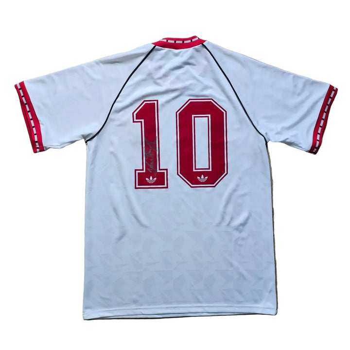 Back of a white Manchester United shirt with red adidas stripes, number 10 in red signed across it, from Mark Hughes's 1990-91 away kit.