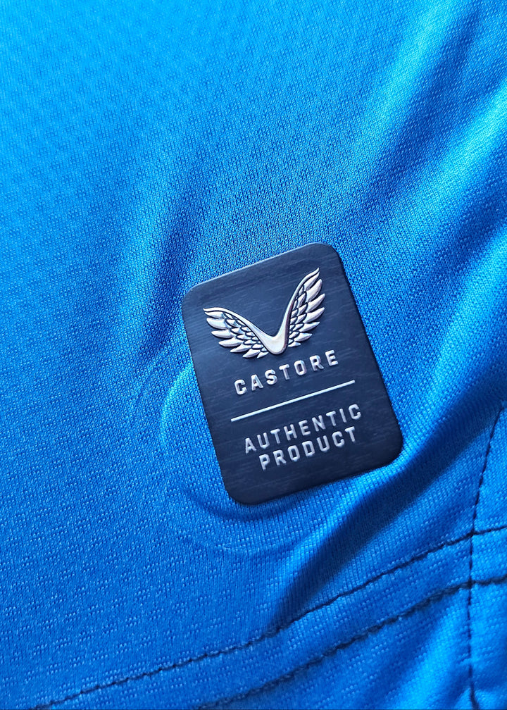 Castore Authentic Product badge on the blue fabric of the Tian Nai Koren Club Brugge 2026-27 home shirt