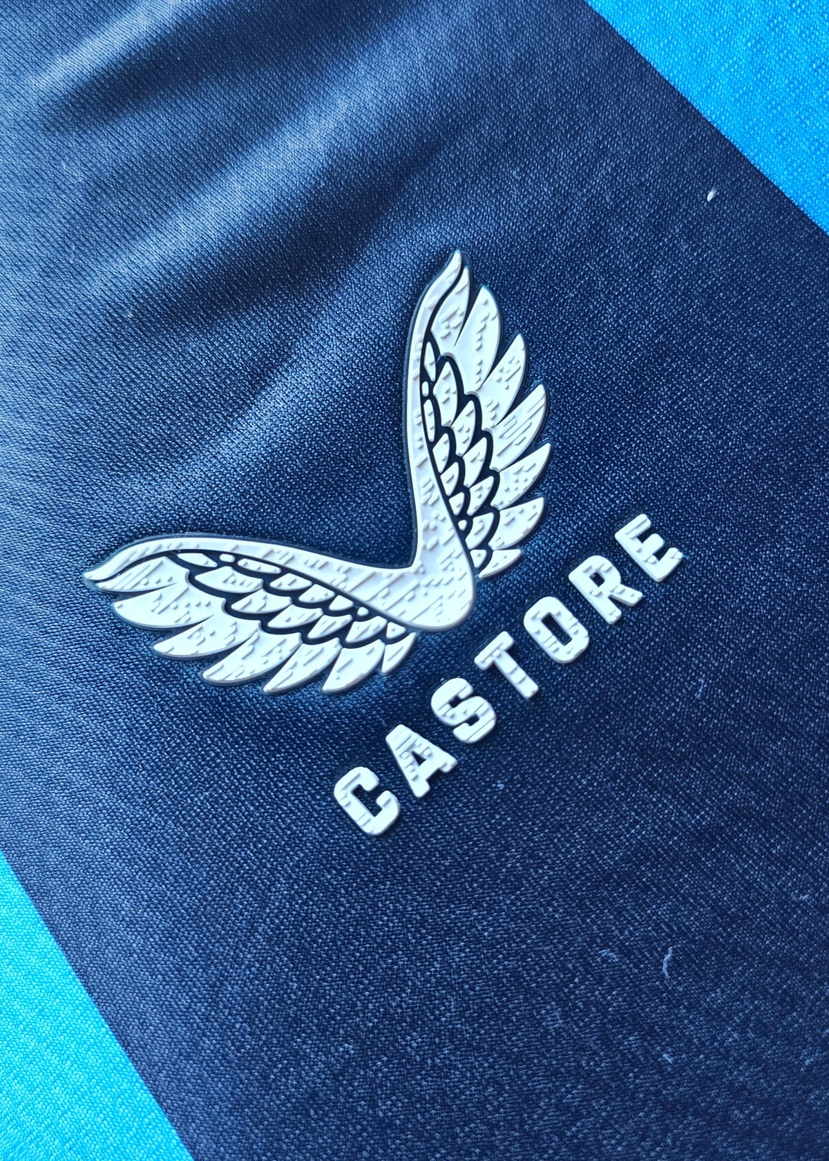White Castore wings logo on the black stripe of the Club Brugge 2026-27 home shirt, Koren 85