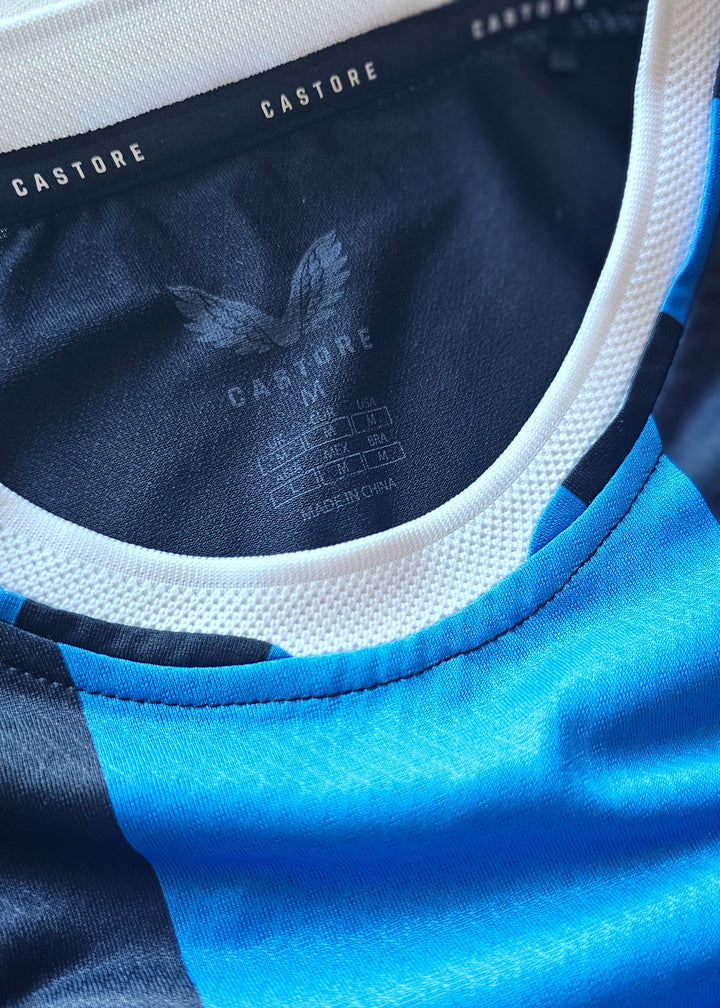 Castore neck tape and inside neck print, size M, made in China, on the black and blue Club Brugge 2026-27 home shirt, Koren 85