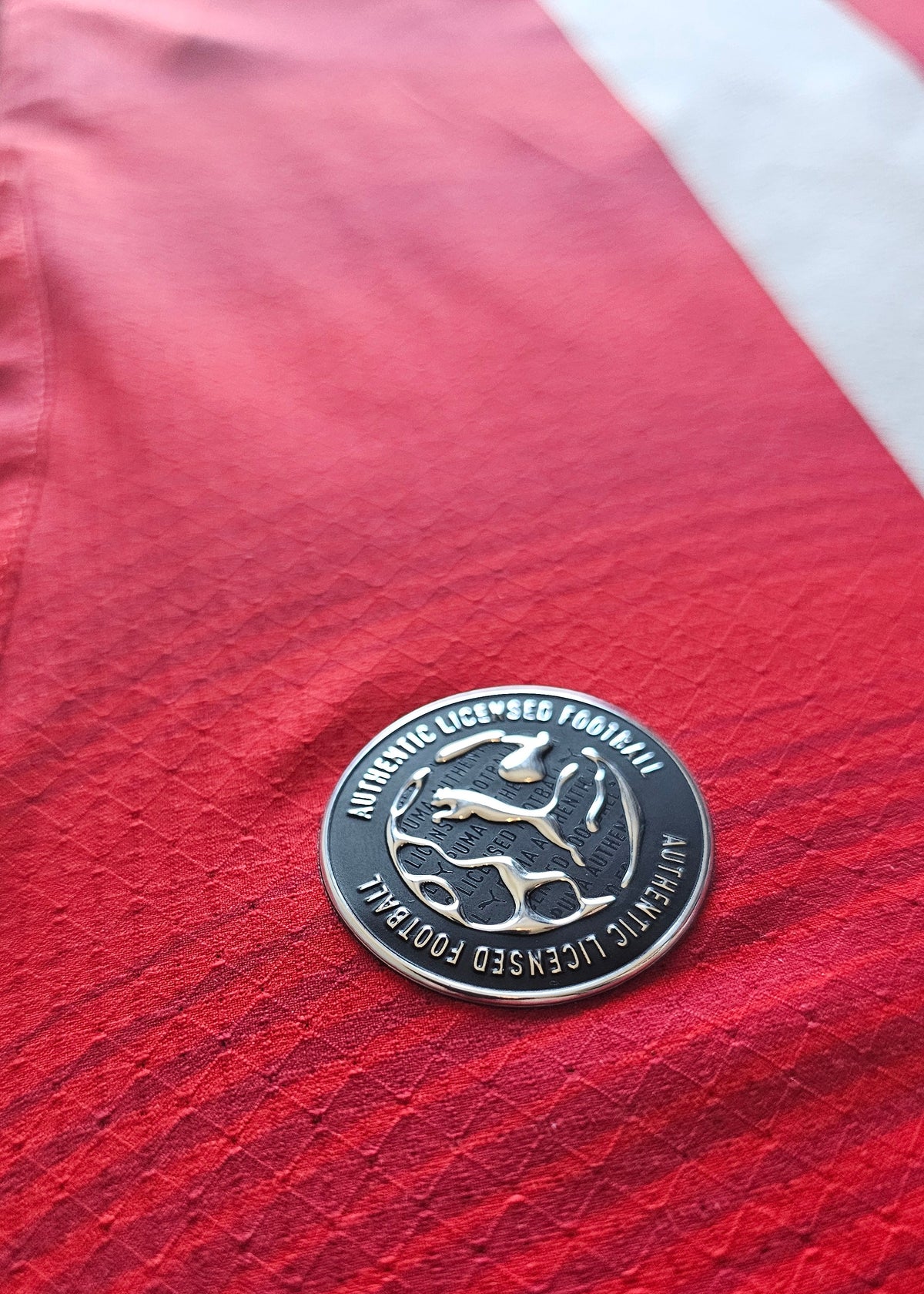 Puma Authentic Licensed Football badge on the red hem of the Amir Bouhamdi PSV 2026-27 home shirt
