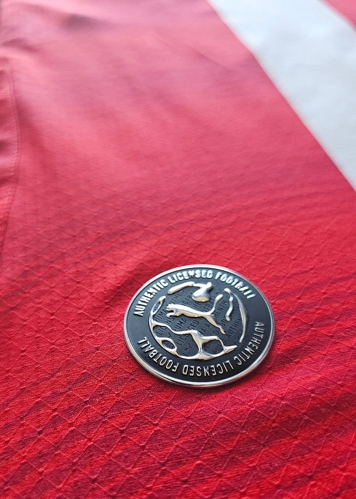 Puma Authentic Licensed Football badge on the red hem of the Amir Bouhamdi PSV 2026-27 home shirt