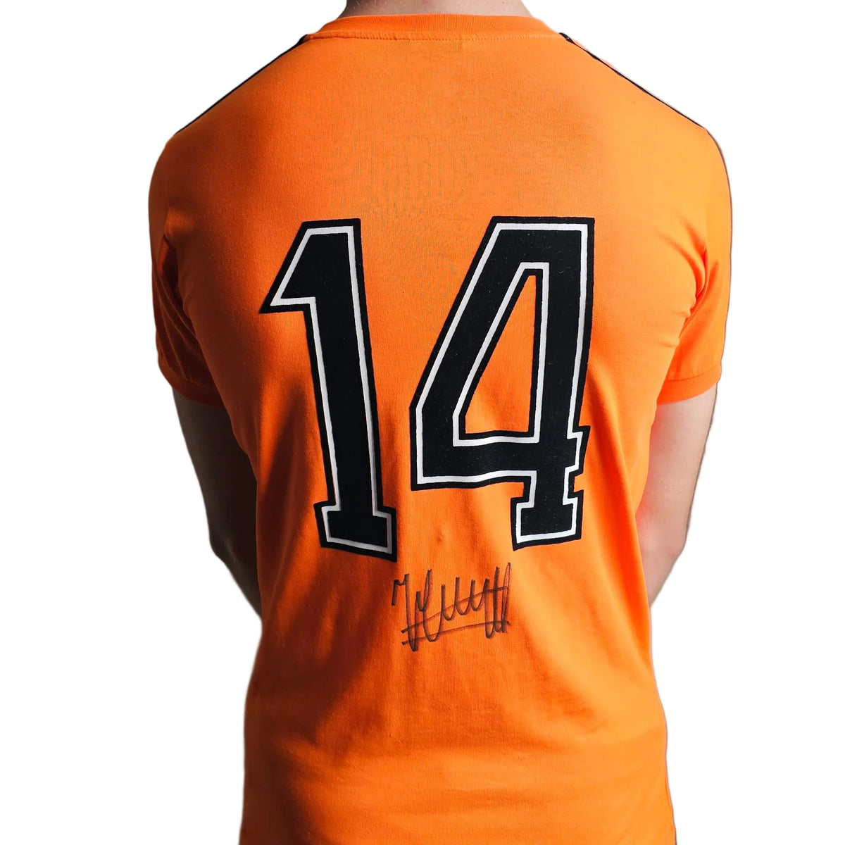 Back of the signed Johan Cruyff Holland 1974 World Cup shirt, orange with the black number 14 and his signature below it
