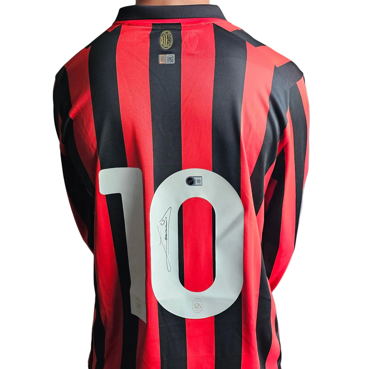 Back of the Ruud Gullit signed AC Milan 125th anniversary shirt, red and black stripes, his signature on the white number 10