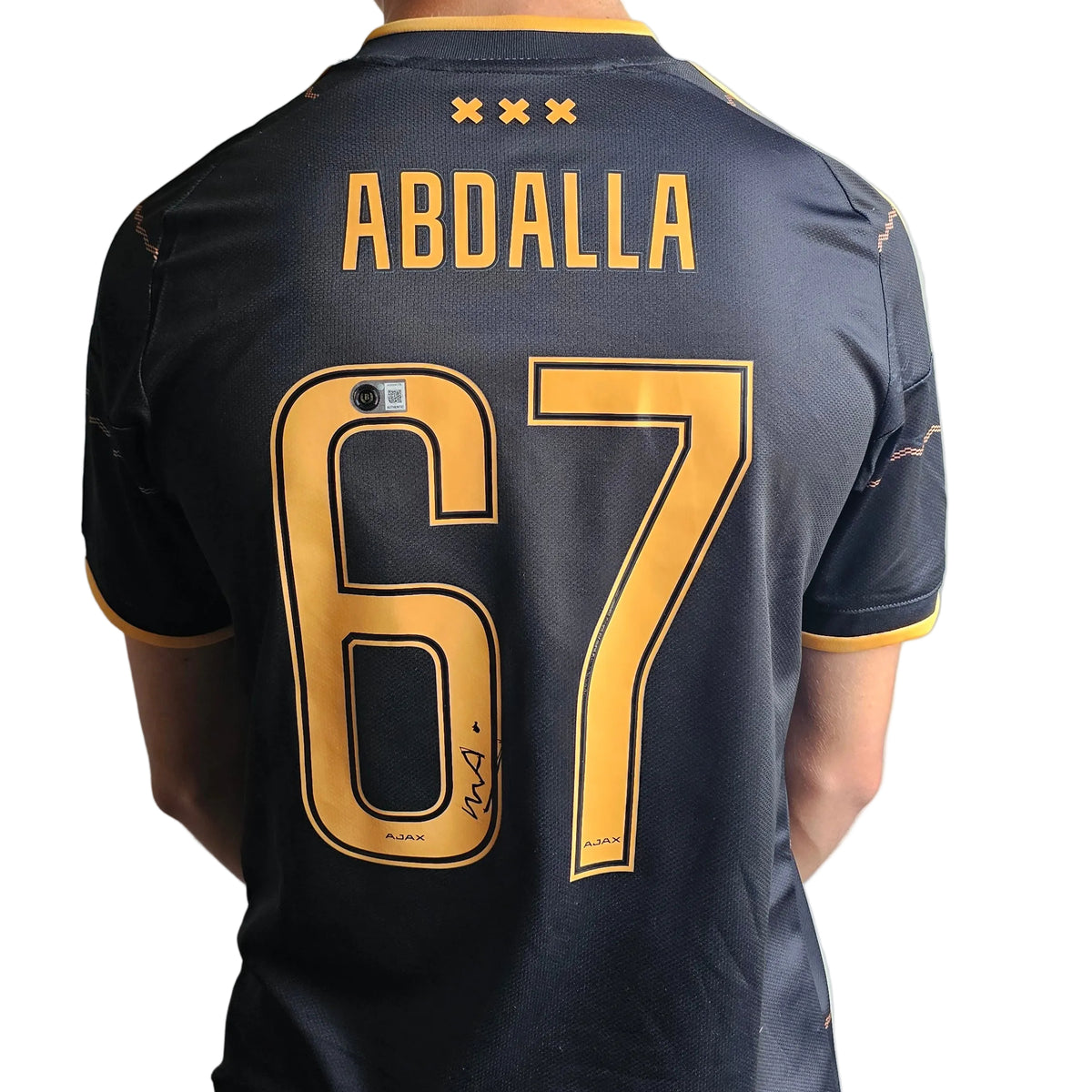 Back of Mohamed Abdalla's signed black Ajax 2026-27 shirt, orange ABDALLA 67 with his signature on the 6