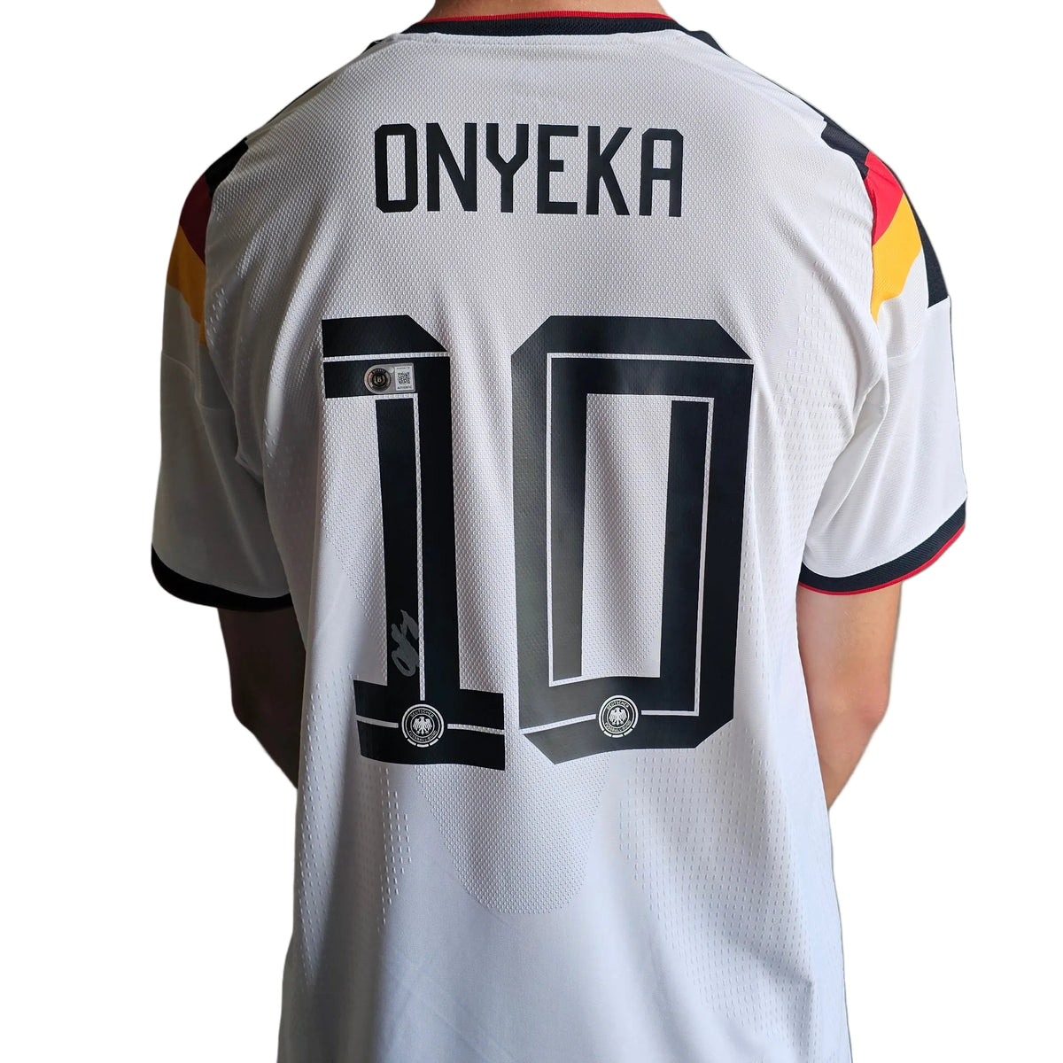 Francis Onyeka's silver signature low on the black 1 of ONYEKA 10, back of his signed Germany 2025-26 home shirt